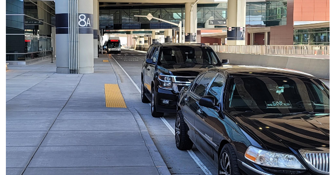 Primo Limo black SUV curbside at SLC Airport